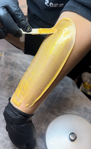 A person with yellow paint on their legs