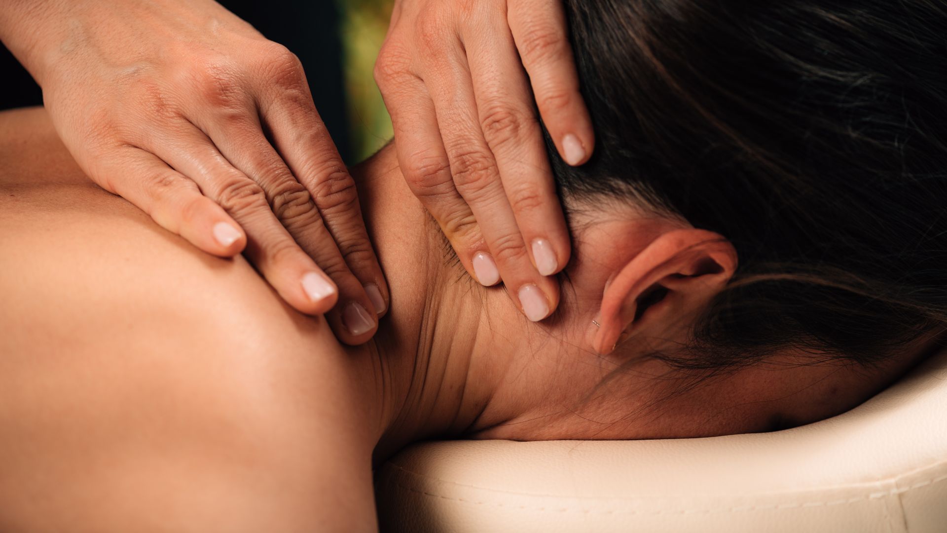 A woman getting a back massage at a spa